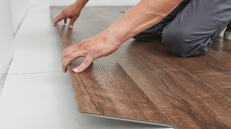 person installing vinyl flooring