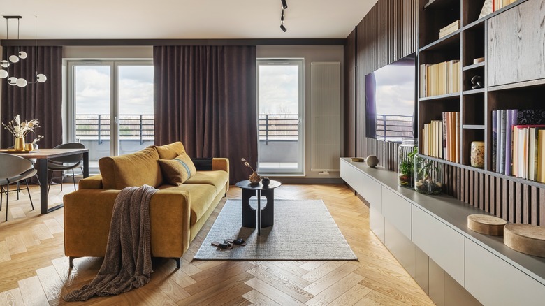 A stylish living room with herringbone wood floors.