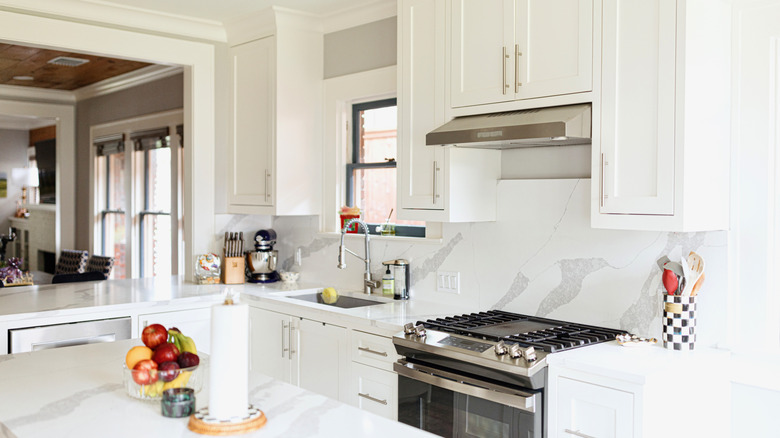 A kitchen with matching marble countertops and backsplash