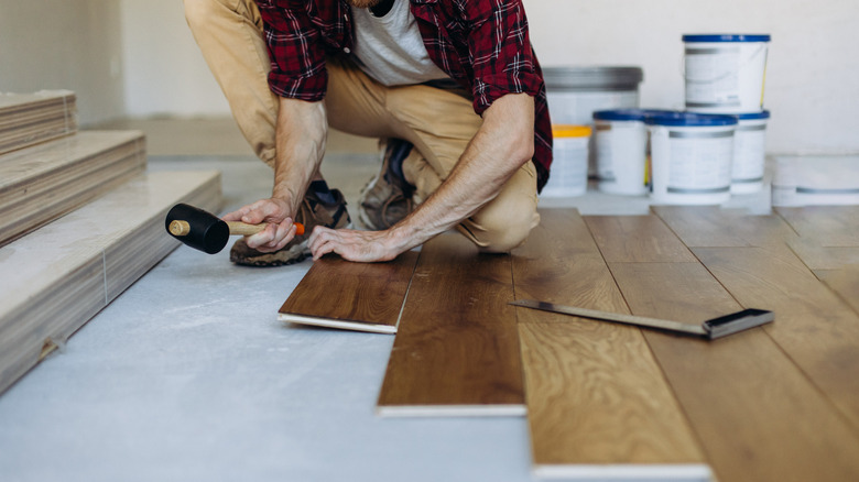 man installing wood flooring