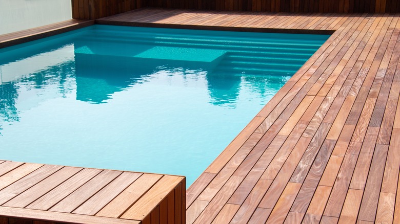 underground pool with wooden deck