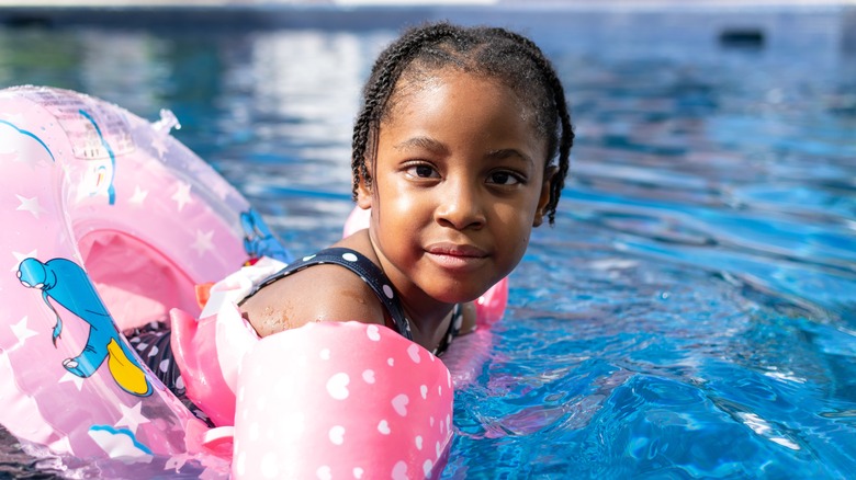 girl swimming in public pool