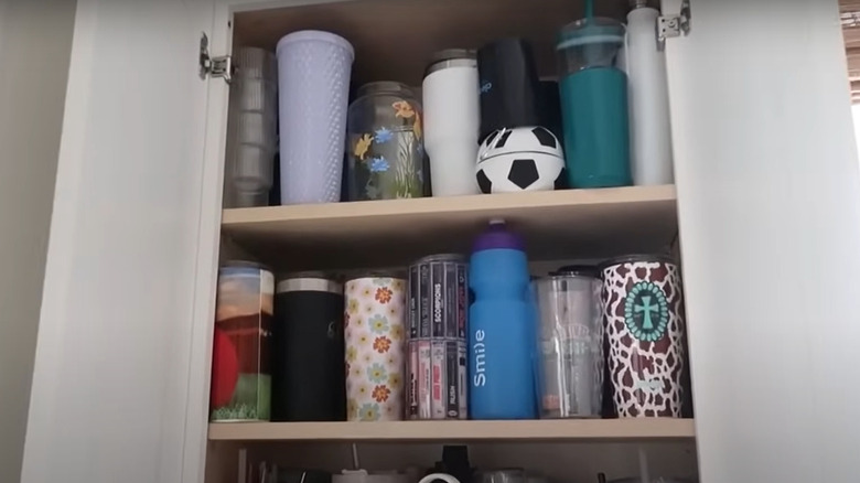 Reusable water bottles filling up a kitchen cabinet