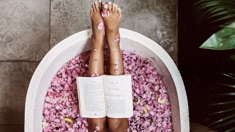 Woman reading in a bath