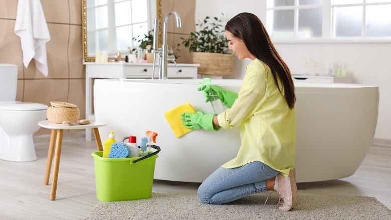 Woman cleaning a bathtub