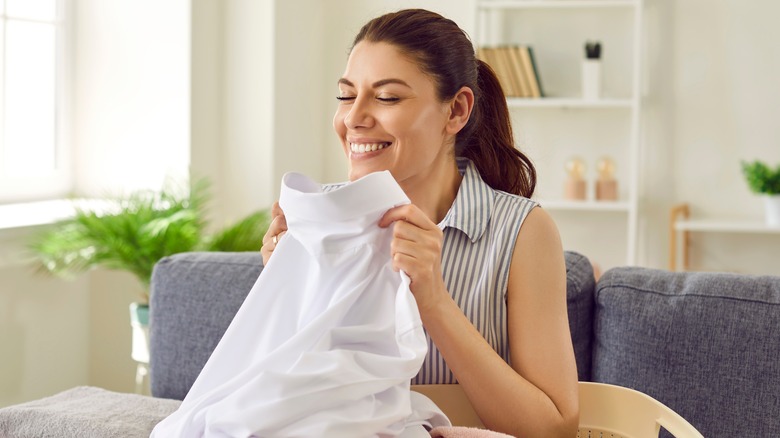 happy woman holding shirt