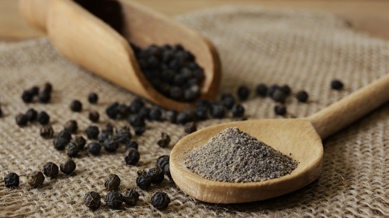 black pepper on wooden spoon