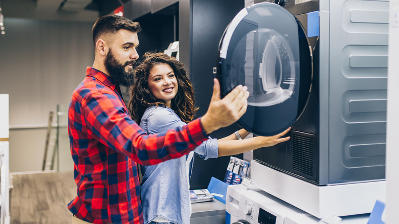 A couple shopping for a washing machine