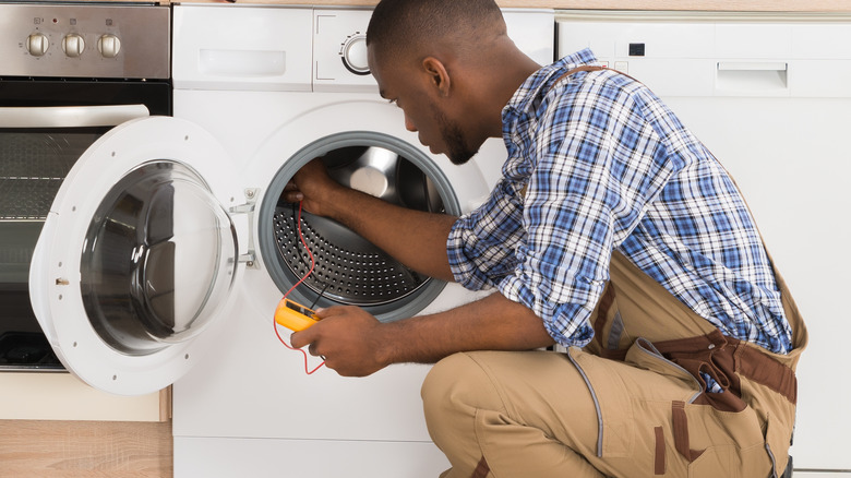 Person repairing washing machine