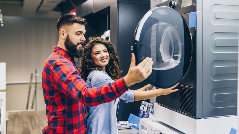 Couple buying laundry machine