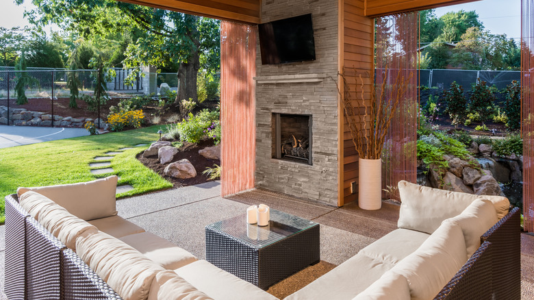 patio with fireplace and TV