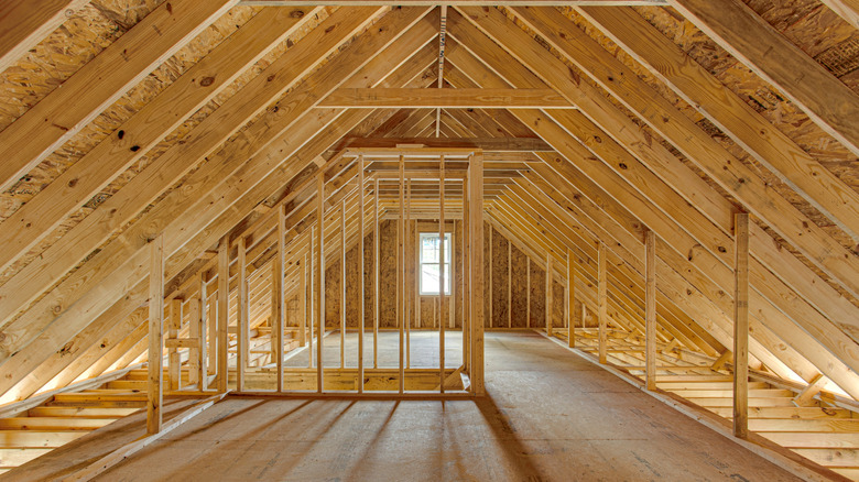 Unfinished attic in home with gable roof