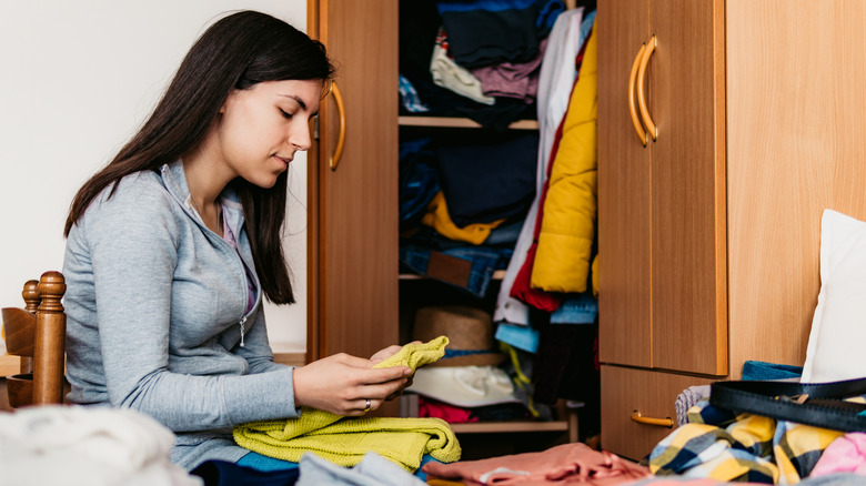 Someone organizing their small closet