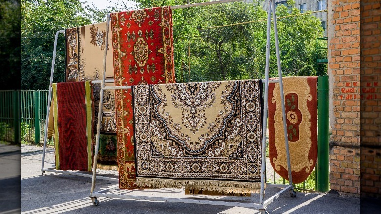 Area rugs hanging outside