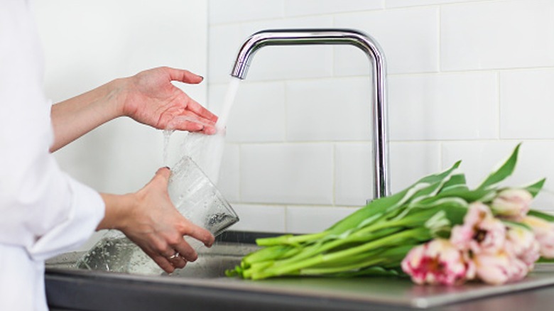 Filling flower vase with water