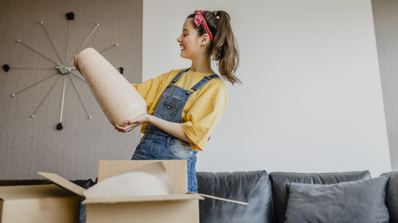 woman unpacking vase