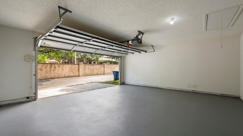 Inside of garage with focus on garage door and opener