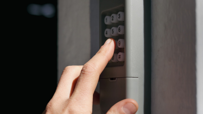 Person using keypad for garage door opener