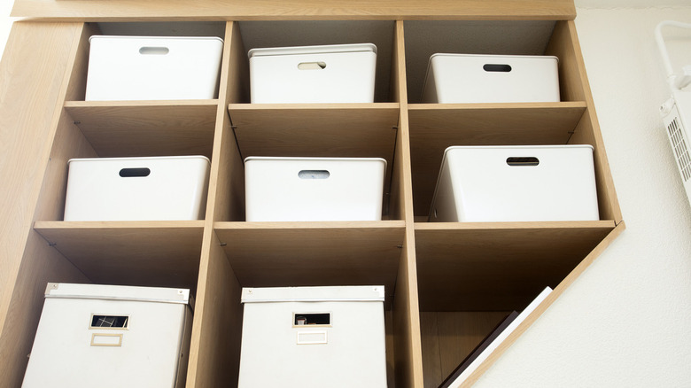 white boxes in wooden shelfs