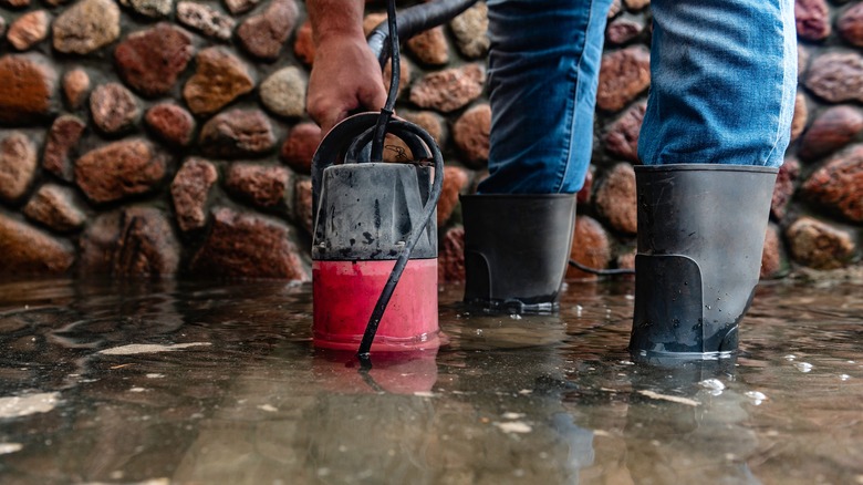 man using submersible pump