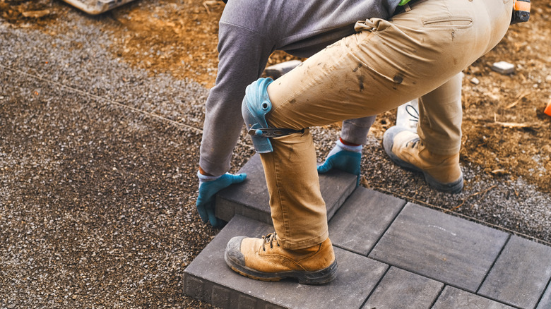 landscaper making stone walkway