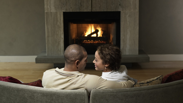 Family sitting in front of fireplace