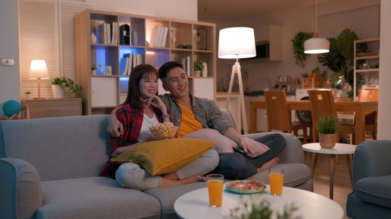 Couple sitting on couch with lamps