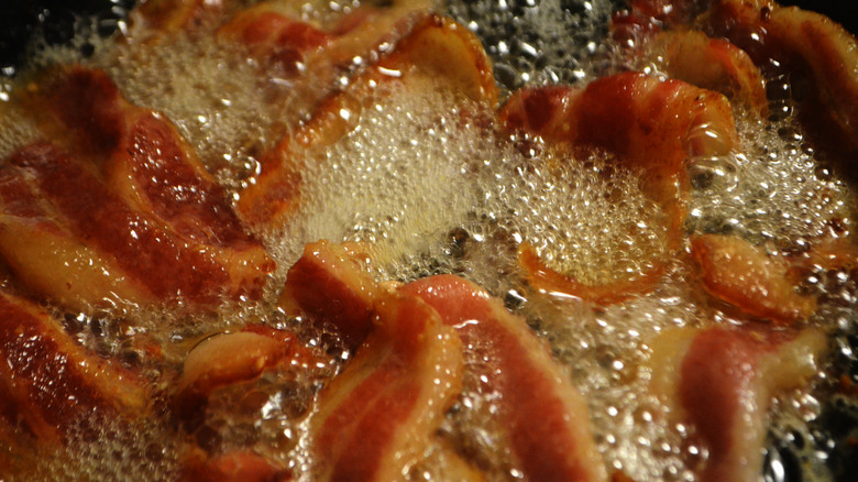 bacon with grease in a frying pan