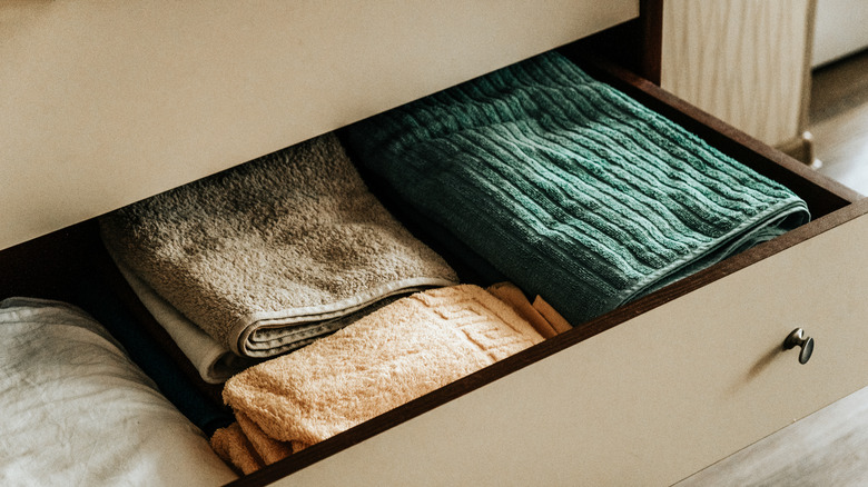 an open drawer containing folded towels