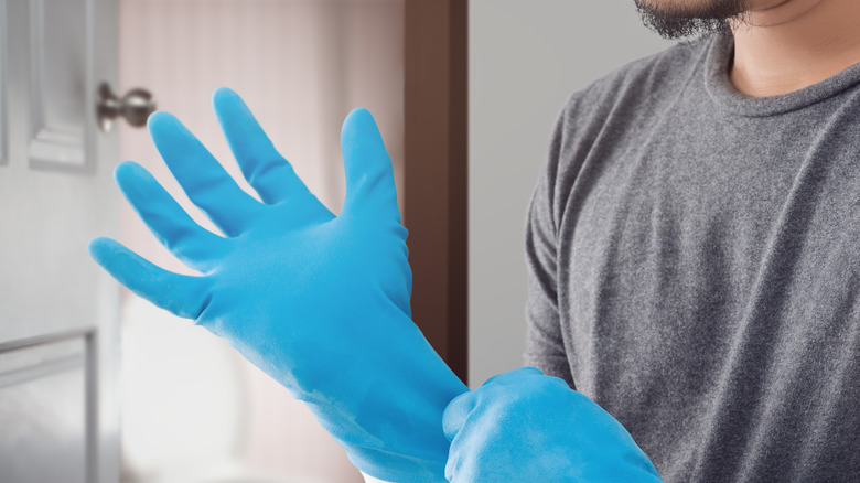 hands putting on rubber gloves