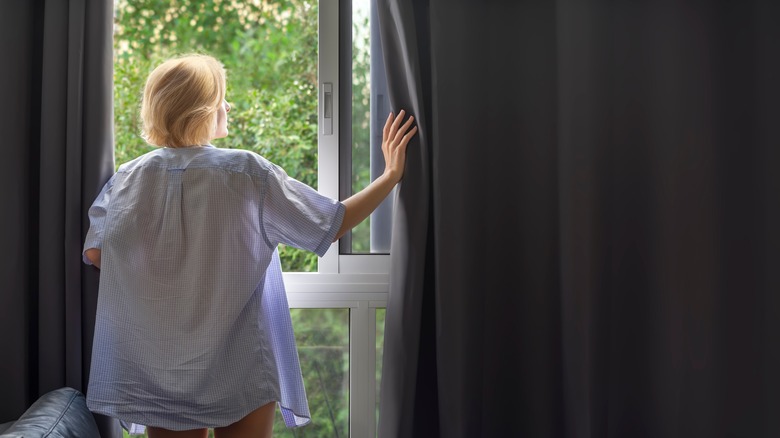 Woman with blackout curtains