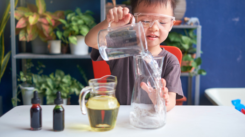 Kid making an oil lamp