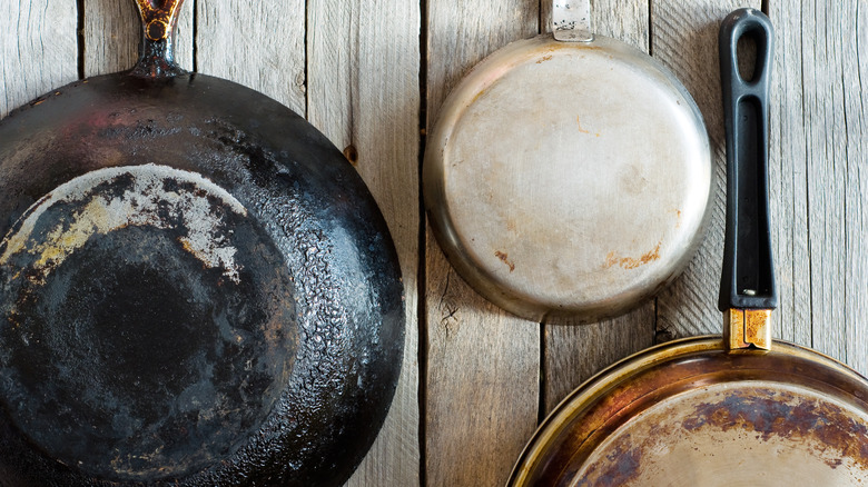 burnt pans on wood surface