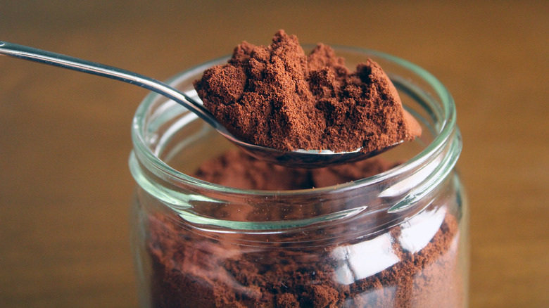 spoon in jar of coffee grounds