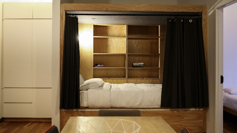 Alcove bed with black curtains 