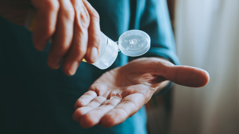  Individual applies hand sanitizer