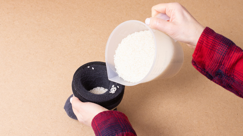 woman filling sock with rice