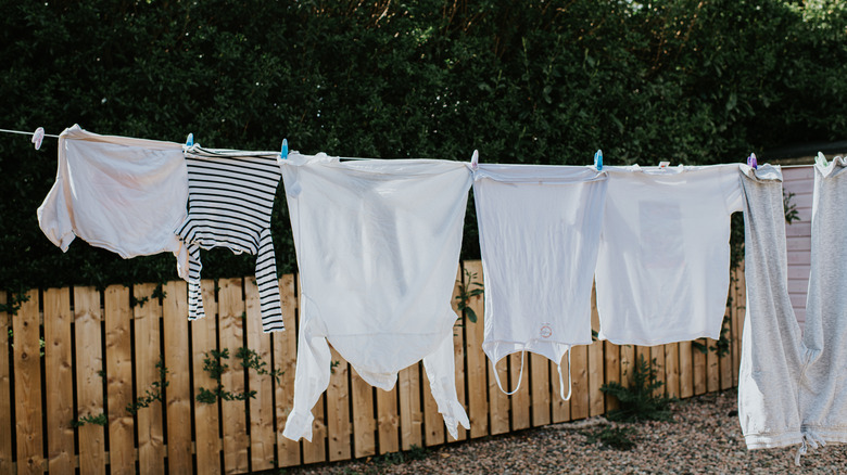 Laundry hanging on a line in the backyard