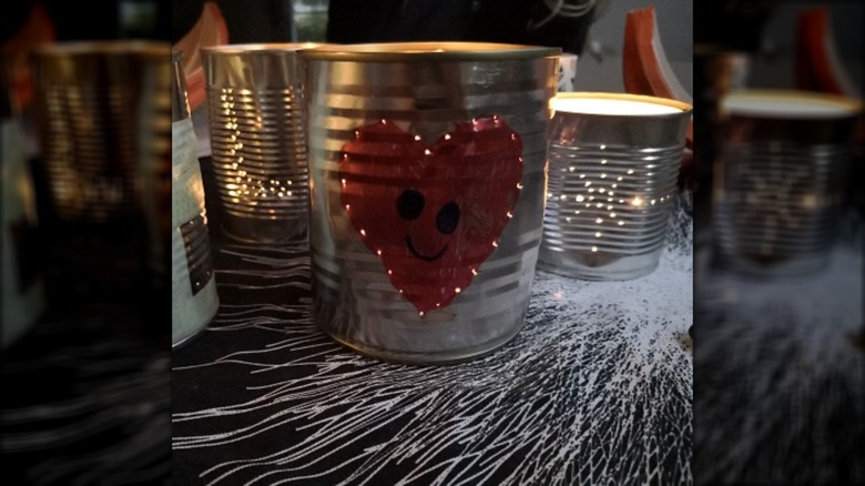 candles in decorated tin cans