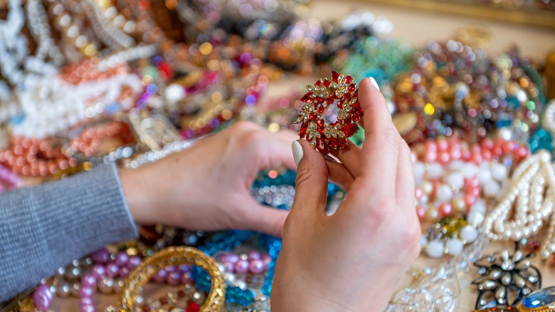 hand holding jeweled brooch