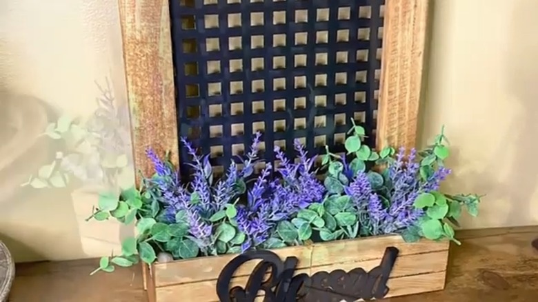 A hanging floral box with wood frame and a Dollar Tree sink mat.