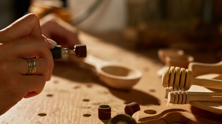 Rotary tool shaping wooden utensils