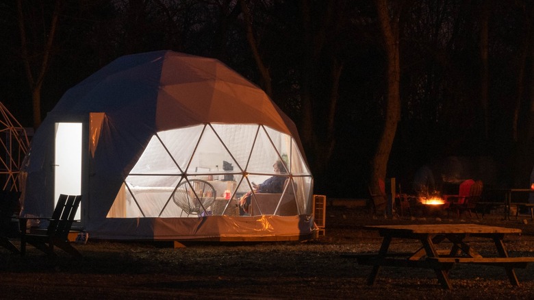 Person inside a geodome at night