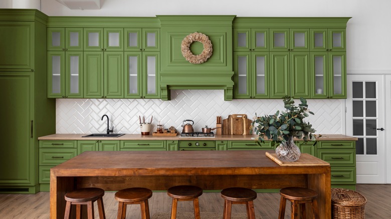 Traditional kitchen with green cabinets