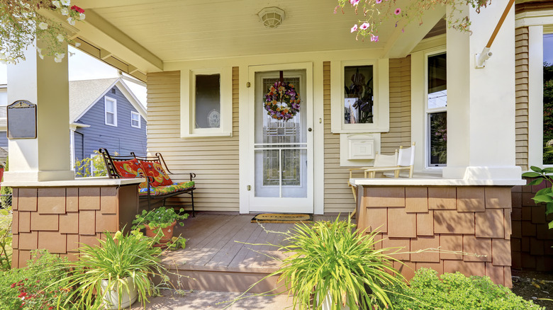 Craftsman house exterior white columns and beige siding