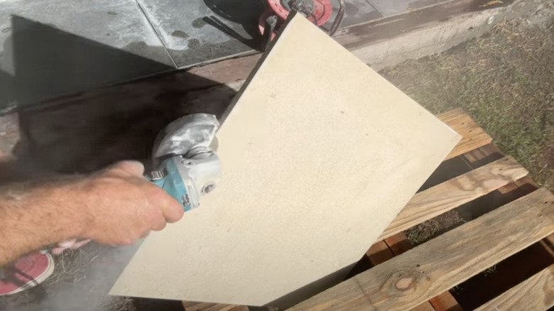 YouTuber tidybrikslandscaping uses a bullnose attachment in use on a porcelain tile