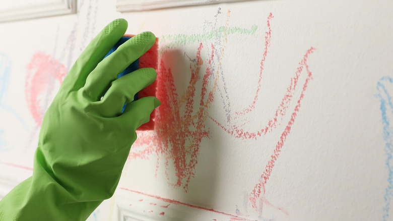 scrubbing crayon-covered wall