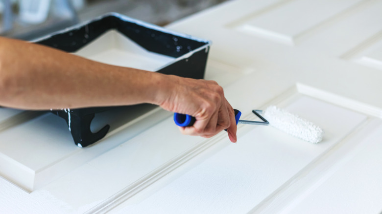 Painting a door with a roller