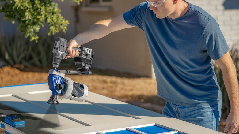 Spray painting a door with the Graco cordless drill attachment