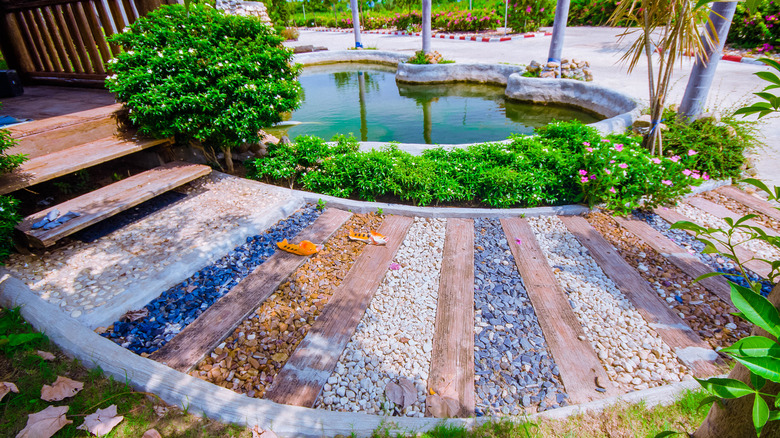 garden with pebbles near pond